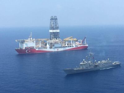 AT SEA, UNSPECIFIED - JULY 11: (----EDITORIAL USE ONLY  MANDATORY CREDIT - "TURKISH NATIONAL DEFENCE MINISTRY / HANDOUT" - NO MARKETING NO ADVERTISING CAMPAIGNS - DISTRIBUTED AS A SERVICE TO CLIENTS----) An aerial photo shows Turkish-flagged drill ship Yavuz' continue offshore drilling operations in company with Turkish battleship in the west of the Island of Cyprus in the Mediterranean Sea on July 11, 2019. Since last spring, Ankara has sent two drilling vessels 'Fatih and most recently Yavuz to the Eastern Mediterranean, asserting the right of Turkey and the TRNC to the resources of the region.








 (Photo by Turkish National Defence Ministry / Handout/Anadolu Agency/Getty Images)