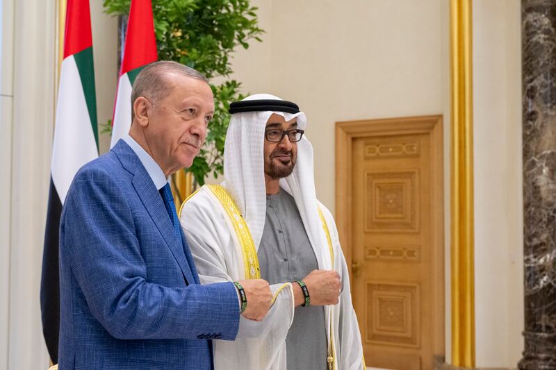 Sheikh Mohamed and Mr Erdogan stand for a photograph wearing Cop28 wristbands. Photo: UAE Presidential Court 
