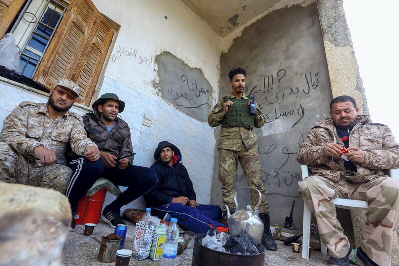 Fighters loyal to the internationally recognised Libyan Government of National Accord (GNA) rest in an area south of the Libyan capital Tripoli on January 12, 2020. - Both sides in Libya's conflict agreed to a ceasefire to end nine months of fighting, following weeks of international diplomacy and calls for a truce by power-brokers Russia and Turkey. The UN-recognised Government of National Accord (GNA) in Tripoli had been under attack since last April from forces loyal to eastern-based strongman Khalifa Haftar, which on January 6 captured the strategic coastal city of Sirte. (Photo by Mahmud TURKIA / AFP)