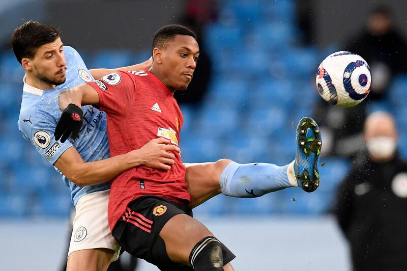 Manchester City's defender Ruben Dias vies with Manchester United's striker Anthony Martial. AFP