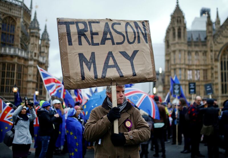 FILE PHOTO:  A pro-Brexit protester holds a banner as anti-Brexit protesters demonstrate outside the Houses of Parliament, ahead of a vote on Prime Minister Theresa May's Brexit deal, in London, Britain, January 15, 2019. To match package "BRITAIN-EU/TIMELINE" REUTERS/Henry Nicholls /File Photo