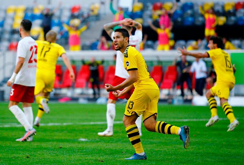 Dortmund's Portuguese defender Raphael Guerreiro, centre, celebrates after Erling Braut Haaland scored against Fortuna Duesseldorf. AFP