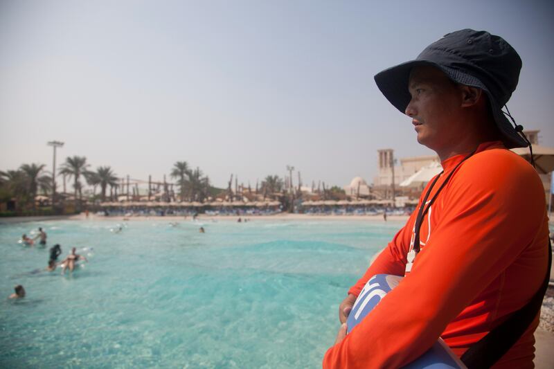 Abu Dhabi, United Arab Emirates - September 16 2015 - Bir Tamang, a Nepalese lifeguard poses for a photo by the wave pool at Yas WaterWorld. Reporter: Gillian Duncan. Section: Business. (Razan Alzayani for The National)  *** Local Caption ***  RA20150916_YasLifeguard_11.jpg RA20150916_YasLifeguard_11.jpg