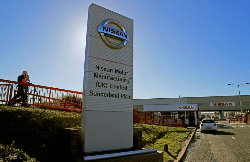 FILE - In this Thursday, March 14, 2019 file photo, workers walk toward the car builders Nissan plant in Sunderland, England. Japanese carmaker Nissan confirmed Friday, Jan. 22, 2021, that it will maintain its operations in Britain in the wake of the post-Brexit trade deal between the country and the European Union. The news was greeted by British Prime Minister Boris Johnson as a â€œgreat vote of confidence.â€ (AP Photo/Frank Augstein, File)
