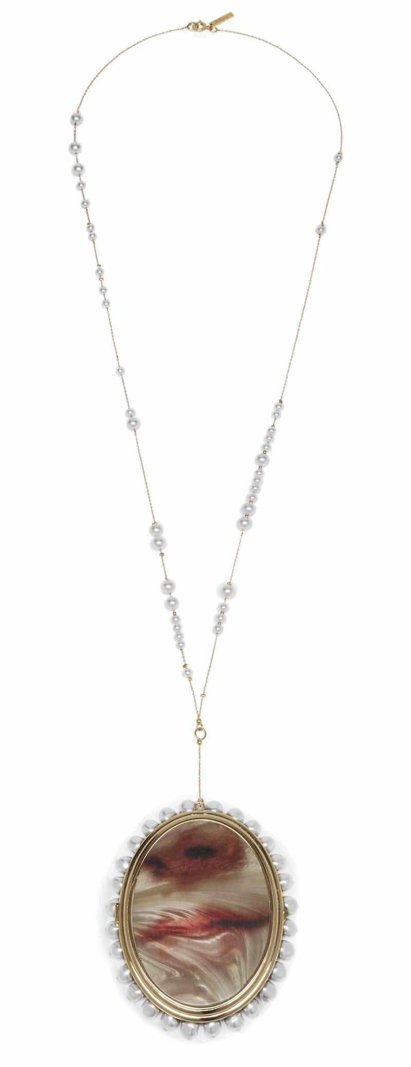 Lips are the focus of this oversized pendant, strung on a chain speckled with pearls