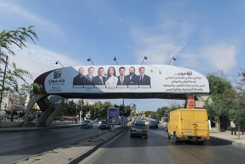 A campaign banner of candidates for the upcoming Jordanian parliamentary elections covers a footbridge on a street in the capital Amman. AFP