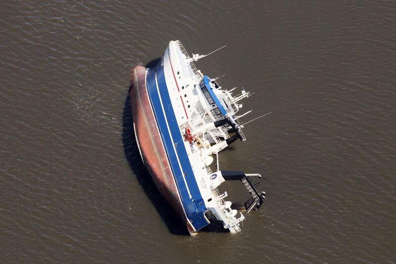 A large ship lists on its side in St Andrew Bay, Panama City. AP Photo