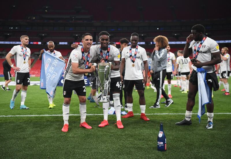 Anthony Knockaert and Steven Sesssgnon of Fulham celebrate with the trophy. Getty