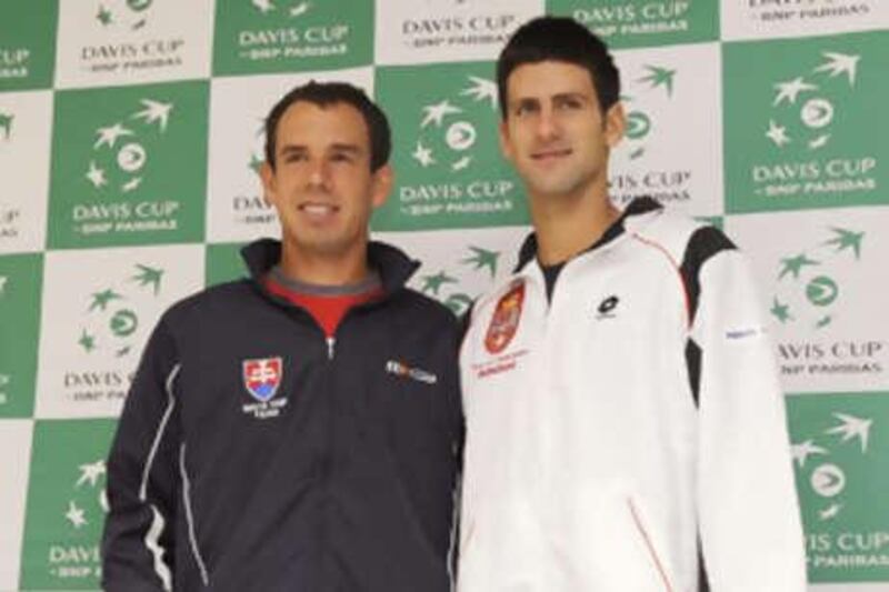 Dominik Hrbaty, left, and Novak Djokovic pose at the end of the draw for of the Davis Cup World Group.