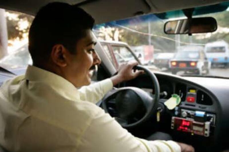 Former lawyer Ali Mohammed Ali, 30, drives his new yellow taxi in Cairo, Egypt.