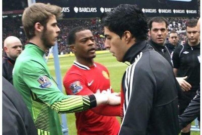 Liverpool's Luis Suarez refused to shake the hand of Patrice Evra of Manchester United ahead of the Premier League match on Saturday at Old Trafford, which United won 2-1.