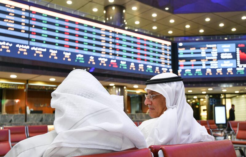 Traders follow stock prices at the Kuwait Stock Exchange in Kuwait City. EPA