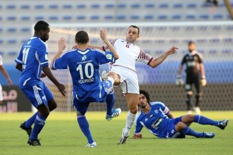 The Al Wahda players, in white, were admittedly nervous against Al Nasr in Dubai last night after a shaky start to their season.