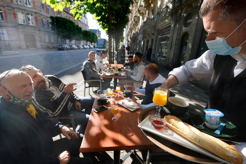 People enjoy a breakfast at a cafe in Strasbourg, eastern France. AP Photo