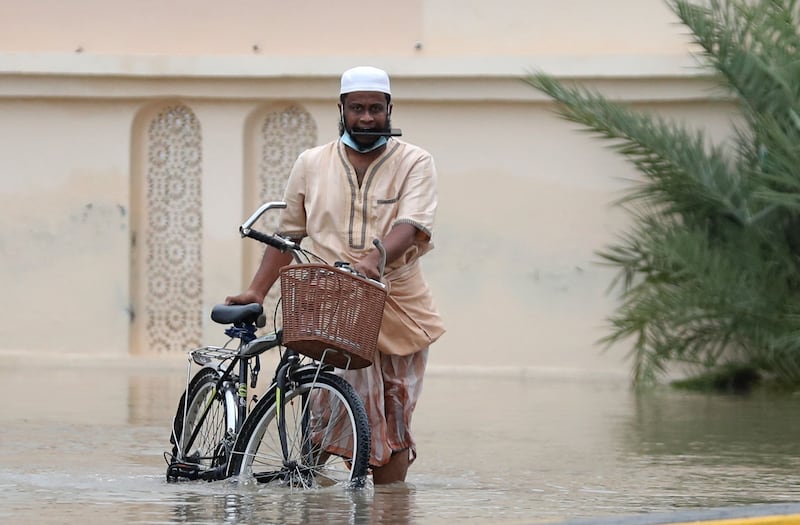 A man wades through floodwaters during the storm in Muscat. AFP