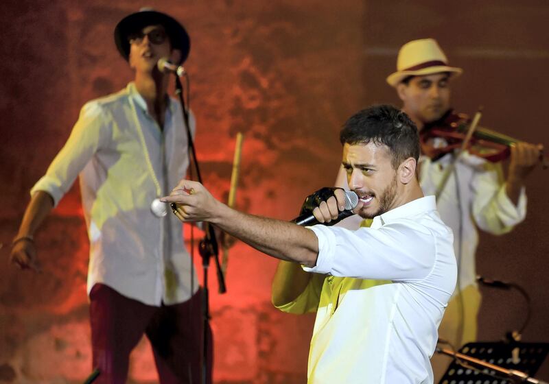 (FILES) In this file photograph taken on July 30,2016, Moroccan singer Saad Lamjarred performs during the 52nd session of the International Carthage Festival at The Roman Theatre of Carthage near Tunis. 
Lamjarred has been charged with "rape" on August 28, 2018, by a district judge of the Draguignan courthouse following a complaint by a young woman, according to the prosecutor's office of Draguignan, southeastern France. / AFP PHOTO / FETHI BELAID