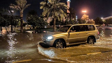 A vehicle moves along a flooded road in Isa Town in southern Bahrain during a heavy rain storm early on April 16, 2024.  Flooding in Oman has killed at least 16 people, many of them schoolchildren, authorities said following the discovery of the bodies of a child and three adults on April 15.  Storms have affected several other Gulf states including Bahrain and the United Arab Emirates.  (Photo by Mazen Mahdi  /  AFP)