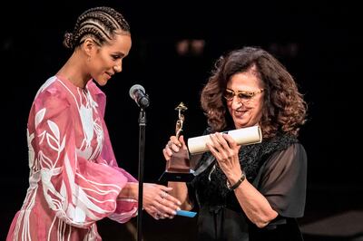 Egyptian producer Marianne Khoury receives the Audience Award from British actress Nathalie Emmanuel (L) during the closing ceremony of the 41st Cairo International Film Festival (CIFF), at the Opera House in Cairo on November 29, 2019. / AFP / Khaled DESOUKI
