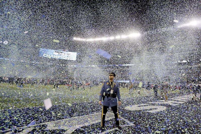 A New Jersey State trooper stands guard on the field as confetti falls following the Seattle Seahawks' victory over the Denver Broncos in the Super Bowl. Ben Margot / AP