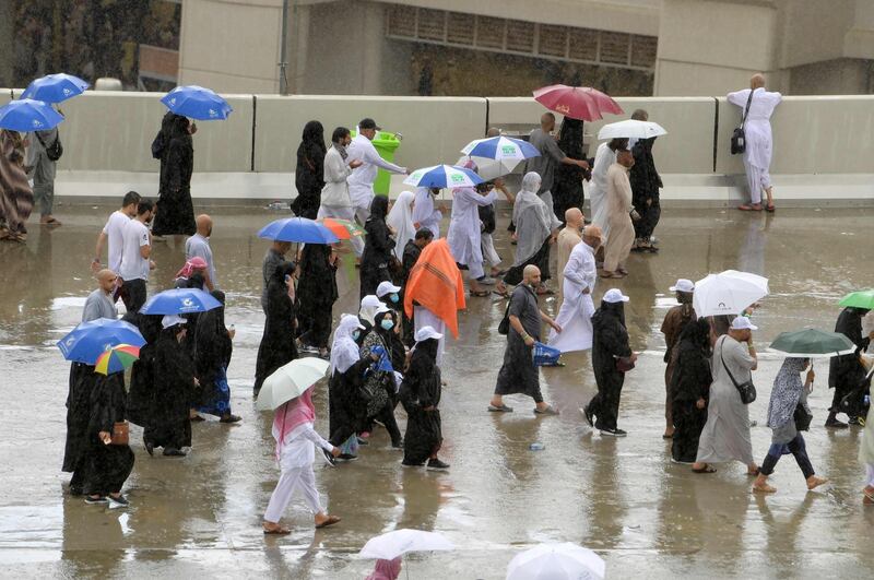 Muslim worshippers arrive in Mina under heavy rain to throw pebbles as part of the symbolic Jamrat Al Aqabah. AFP