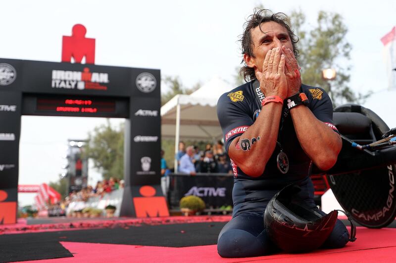 CERVIA, ITALY - SEPTEMBER 22:  Racing Driver Alessandro Zanardi of Italy celebrates finishing IRONMAN Emilia Romagna on September 21, 2018 in Cervia, Italy.  (Photo by Bryn Lennon/Getty Images for IRONMAN)