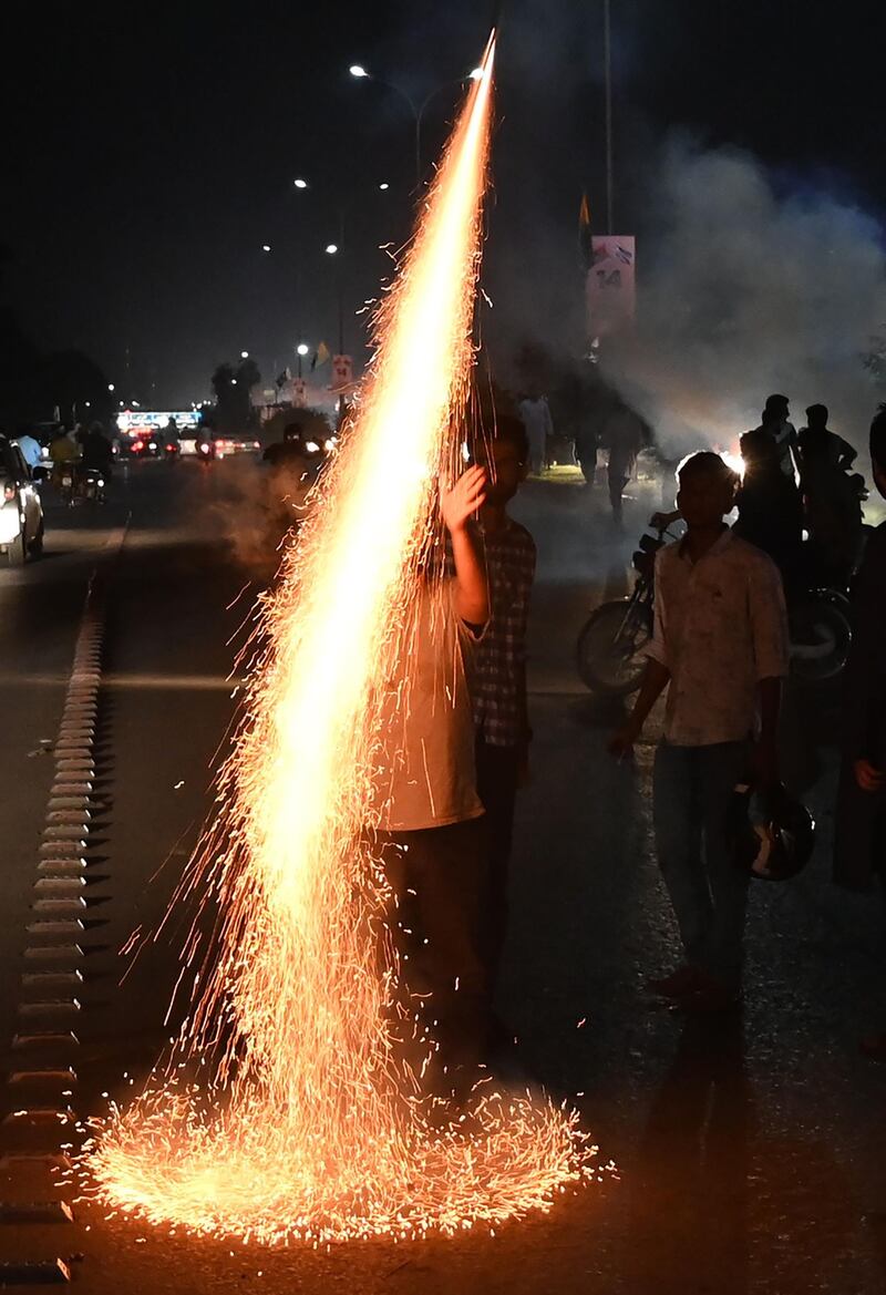 Pakistanis light fireworks.  AFP