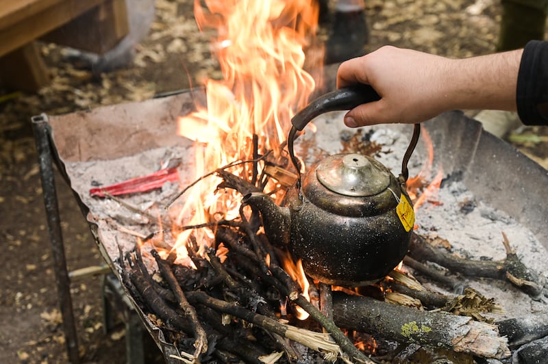 A kettle is boiled over the campfire in Fneidek forest. Photo: Finbar Anderson /The National