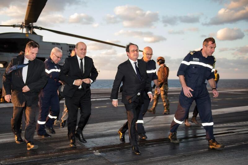 France's president Francois Hollande visits the Charles De Gaulle aircraft carrier operating off Syria in the Mediterranean sea. AP