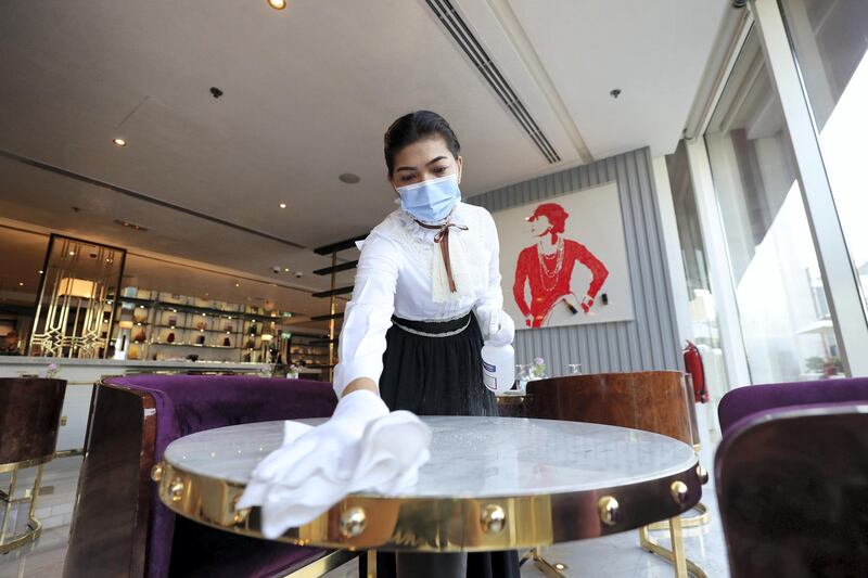 Dubai, United Arab Emirates - Reporter: N/A. News. Coronavirus/Covid-19. An employee at disinfects a table before welcoming customers in Dubai. Wednesday, November 11th, 2020. Dubai. Chris Whiteoak / The National