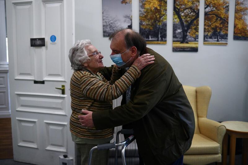 Stephen Crowe hugs his mother Susan Crowe, 96, who is a resident at Alexander House Care Home in Wimbledon, London, as coronavirus restrictions continue to ease. Reuters