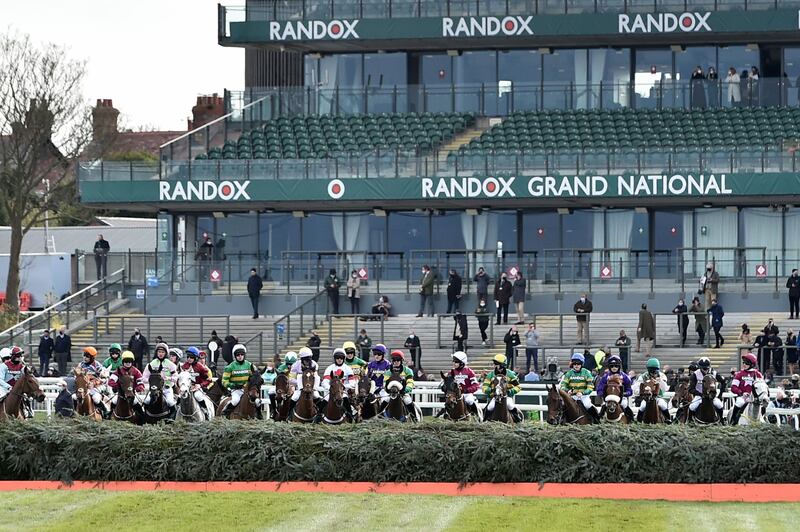 Horses gather, with empty stands in the background, before the start of the Grand National . AP