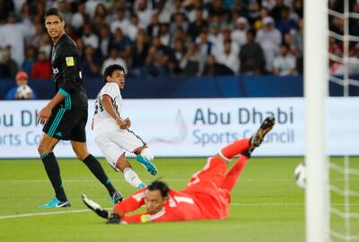 Al Jazira's Romarinho, left, scores the opening goal during the Club World Cup semifinal soccer match between Real Madrid and Al Jazira Club at Zayed sport city in Abu Dhabi, United Arab Emirates, Wednesday, Dec. 13, 2017. (AP Photo/Hassan Ammar)