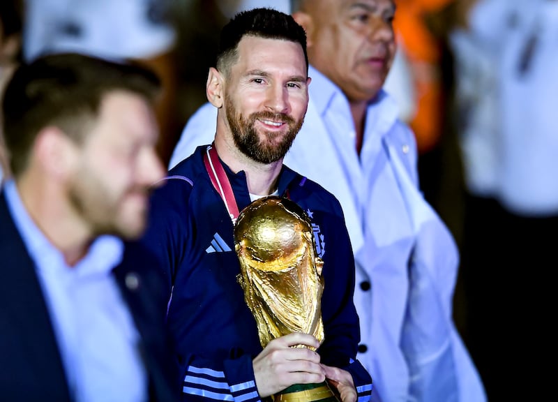 Lionel Messi holds the World Cup trophy. Getty