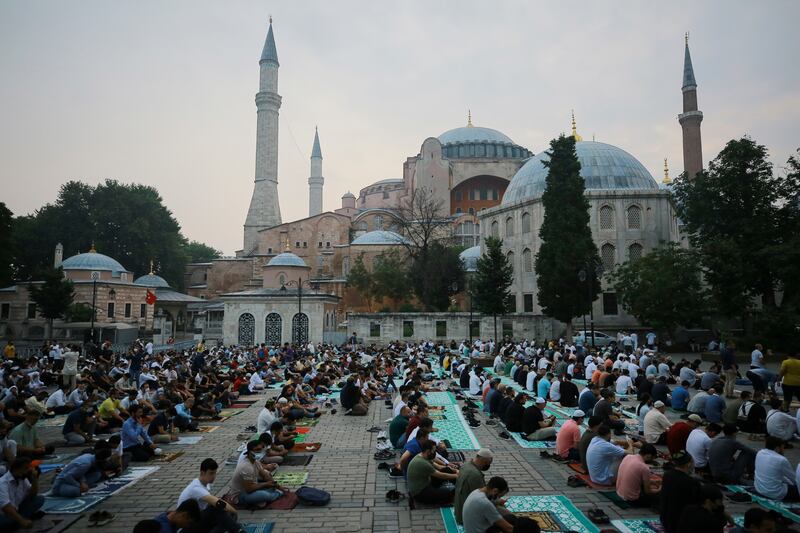 Muslims offer prayers during the first day of Eid Al Adha, outside the Hagia Sophia in the historic Sultan Ahmed district of Istanbul, Turkey.