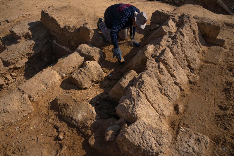 A member of a Palestinian excavation team works in a newly discovered Roman era cemetery in the Gaza Strip, Sunday, Dec.  11, 2022.  Hamas authorities in Gaza announced the discovery of over 60 tombs in the ancient burial site.  Work crews have been excavating the site since it was discovered last January during preparations for an Egyptian-funded housing project.  (AP Photo / Fatima Shbair)