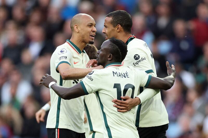 Joel Matip celebrates with teammates. Action Images