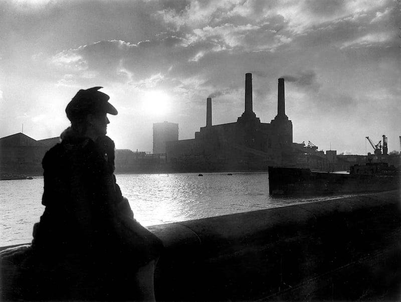 A woman looks across the Thames towards Battersea Power Station in 1945. Alamy