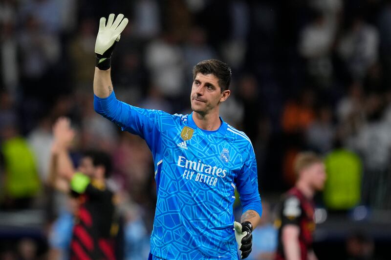 FILE - Real Madrid's goalkeeper Thibaut Courtois waves to fans at the end of the Champions League semifinal first leg soccer match between Real Madrid and Manchester City at the Santiago Bernabeu stadium in Madrid, Spain, Tuesday, May 9, 2023.  Real Madrid says goalkeeper Thibaut Courtois has torn a ligament in his left knee and will require surgery.  Local media reports that the injury occurred during training.  (AP Photo / Manu Fernandez, File)