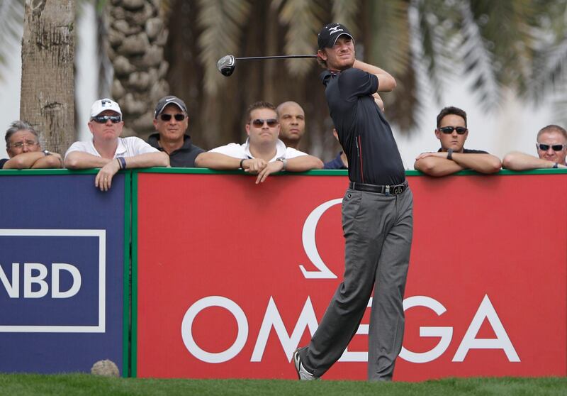 England's Chris Wood plays a ball on the 9th hole during the second round of the Dubai Desert Classic Golf tournament in Dubai, United Arab Emirates, Friday, Feb. 1, 2013. (AP Photo/Kamran Jebreili) *** Local Caption ***  Mideast Emirates Golf Desert Classic.JPEG-02620.jpg