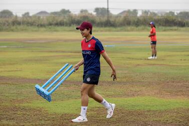 This picture taken on April 19, 2022 shows Natthakan Chantam of Thailand's women's national cricket team carrying a wicket during a training session in Bangkok.  - In a country where a Muay Thai right hook is more familiar than a batter's hook shot, Thailand's pioneering women cricketers are winning hearts with smiles, dance moves -- and skill.  (Photo by Jack TAYLOR  /  AFP)  /  To go with Cricket-THA-women, FEATURE by Lisa MARTIN