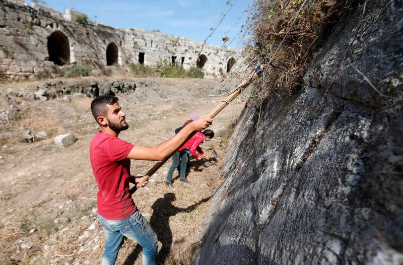 Volunteers take part in a clean-up at the medieval crusader fortress Krak des Chevaliers, just west of Syria's central city of Homs. AFP