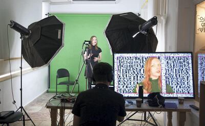American artist Blake Shaw's work shows a female presenter stood in front of a green screen. Courtesy of Palestinian Art Court - Alhoash