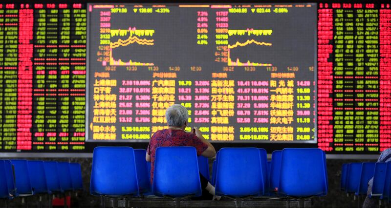 An investor looks at an electronic board showing stock information at a brokerage house in Shanghai, August 25, 2015. China's major stock indexes sank more than 6 percent in early trade on Tuesday, after a catastrophic Monday that saw Chinese exchanges suffer their biggest losses since the global financial crisis, destabilizing financial markets around the world. REUTERS/Aly Song      TPX IMAGES OF THE DAY