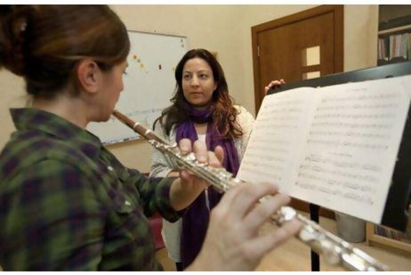Tala Badri, right, conducts a flute lesson at the Centre for Musical Arts that she founded in Dubai.