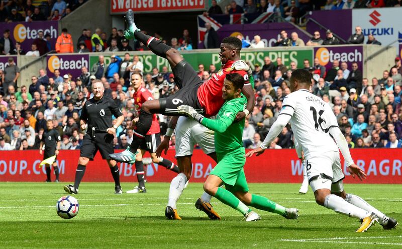 Soccer Football - Premier League - Swansea City vs Manchester United - Swansea, Britain - August 19, 2017   Swansea City's Lukasz Fabianski collides with Manchester United's Paul Pogba    REUTERS/Rebecca Naden     EDITORIAL USE ONLY. No use with unauthorized audio, video, data, fixture lists, club/league logos or "live" services. Online in-match use limited to 45 images, no video emulation. No use in betting, games or single club/league/player publications. Please contact your account representative for further details.