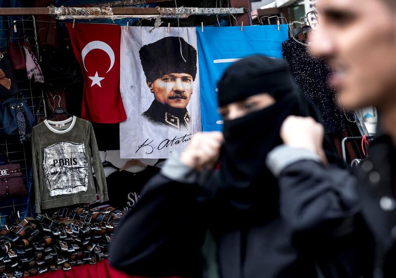 epa06677503 People walk in front of the picture of Mustafa Kemal Ataturk as they shop at Eminonu bazaar in Istanbul, Turkey, 18 April 2018. Turkish President Recep Tayyip Erdogan announced on 18 April 2018 that Turkey will hold the snap election on 24 June 2018. The presidental and parliamentary elections were scheduled to be held in November 2019, but government has decided the change the date following the recommendation of the Nationalist Movement Party (MHP) leader Devlet Bahceli.  EPA/SEDAT SUNA