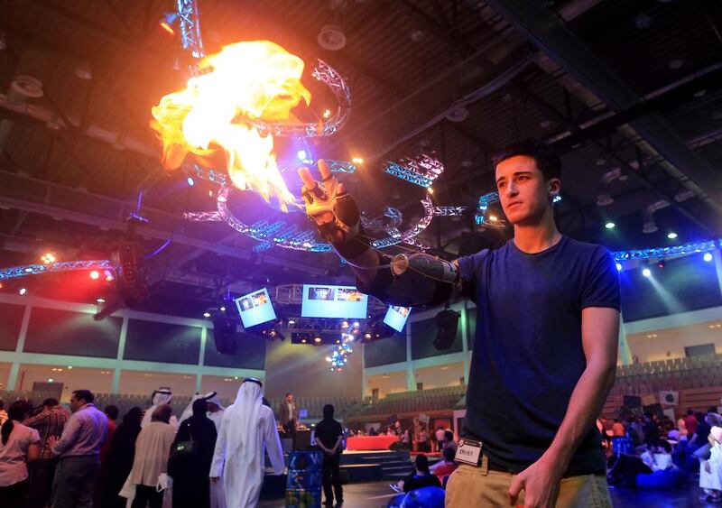 Xavier Goby, grade 12 student from Deira International School, Dubai and the Inkover flame thrower to visitor at the Innovator 2014 Exhibition in FGB arena at Zayed Sports city in Abu Dhabi. Ravindranath K / The National