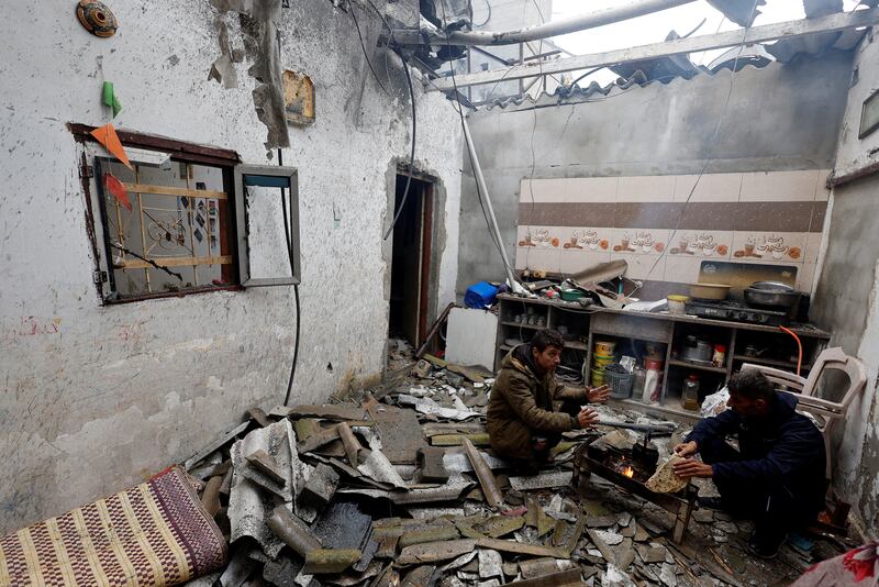 Palestinians shelter in a building damaged by Israeli strikes in Rafah, in the southern Gaza Strip. Reuters