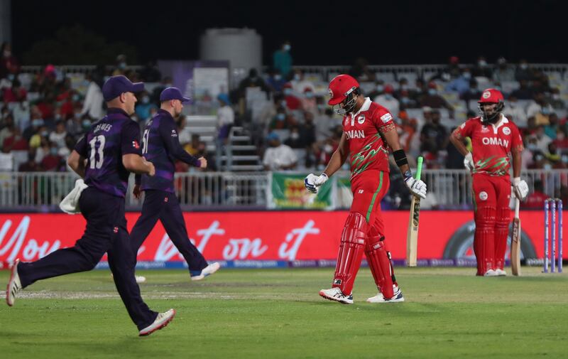 Oman's batsman Naseem Khushi, second from right, after being dismissed by Scotland's Michael Leask. AP