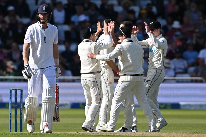 New Zealand players congratulate Trent Boult as Zak Crawley walks back to the pavilion after losing his wicket. AFP